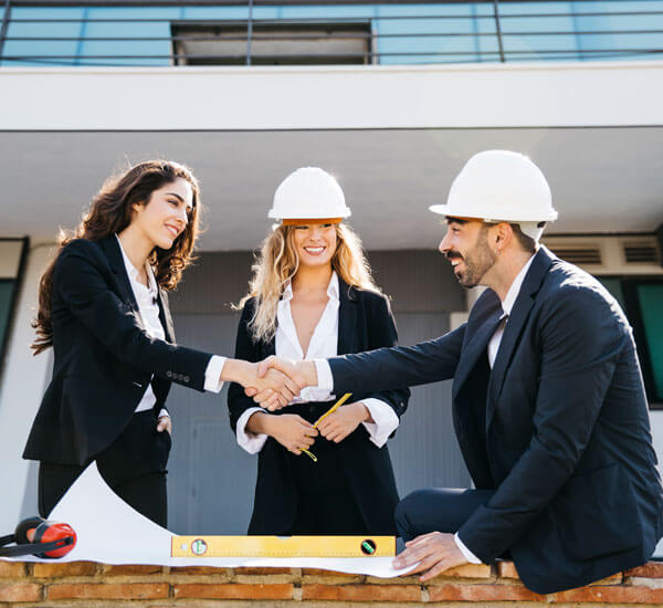 People meeting over building plans at a worksite
